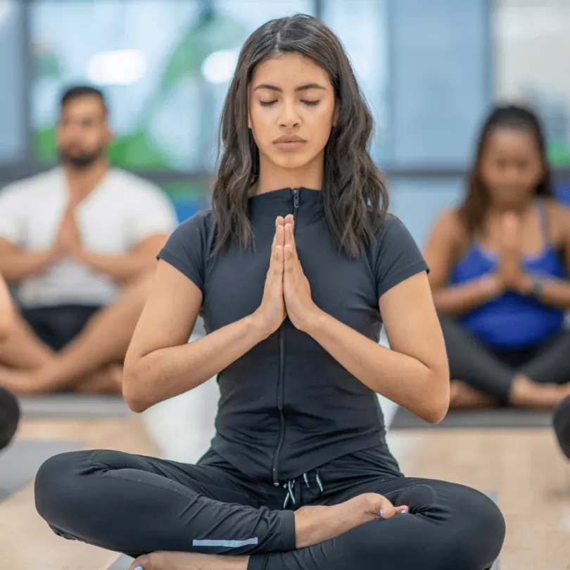 Woman in group yoga class.