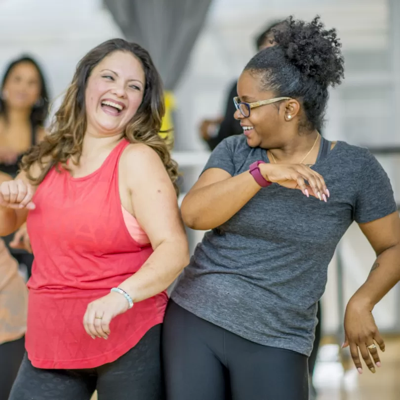 Two woman dancing and laughing 